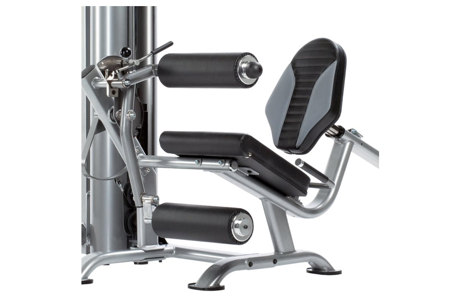 TuffStuff Apollo leg extension and curl machine with silver steel frame, black padded seat and leg pads on white background