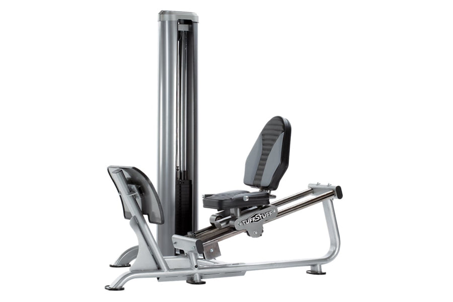 TuffStuff Apollo leg press machine with silver frame, black padded seat and backrest, and vertical weight stack on white back