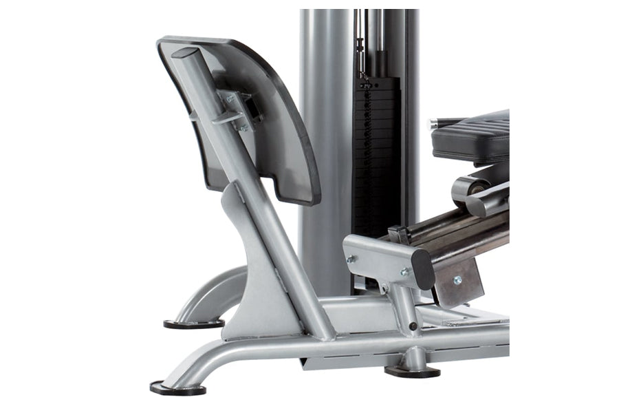 Silver and black leg press machine with padded seat and footplate on white background