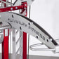 TuffStuff CT8 Compact Fitness Training System with red frame, silver handles, and "TuffStuff Fitness" branding on gray panel