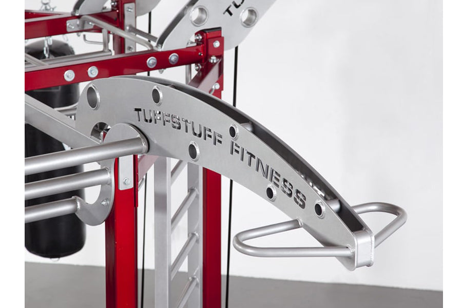 TuffStuff Fitness red and silver multi-system exercise equipment with curved handles and adjustment holes on white background