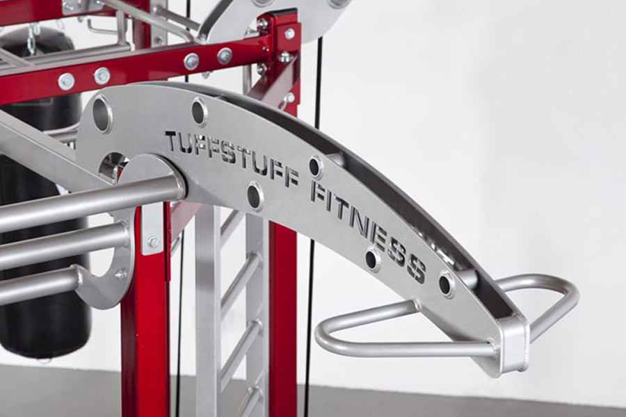TuffStuff Fitness stainless steel weight machine with red frame and curved handle bar on white background