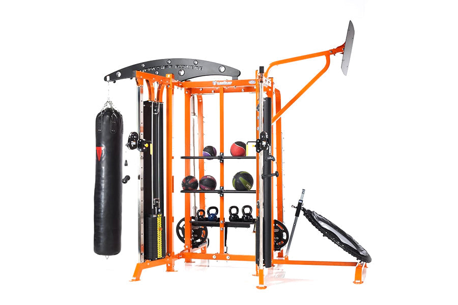 Multi-station gym equipment with bright orange frame, featuring punching bag, shelves with weights and kettlebells, cable mac