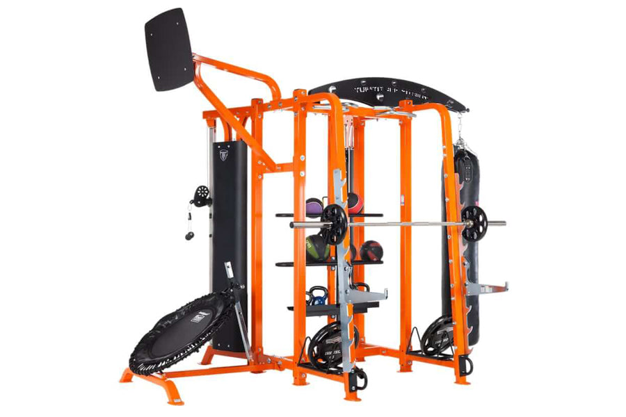 TuffStuff orange and black multi-station workout system with pull-up bar, weight plates, and exercise equipment on white back