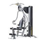 TuffStuff Classic home gym with silver frame, black seat, cable machine arms, and leg press attachment on white background
