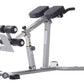 Gray adjustable hyper-extension bench with dual black leg extension pads, padded seat, and integrated dumbbell holders on whi