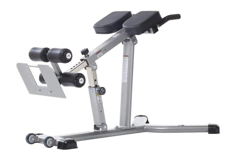Gray adjustable hyper-extension bench with dual black leg extension pads, padded seat, and integrated dumbbell holders on whi