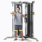 Man using dual-cable functional trainer with smith press attachment, gray and black gym equipment on white background