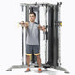 Man using black and gray multi-functional trainer with yellow handles and accents, demonstrating cable machine exercise on wh