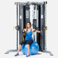 Woman in blue tank top and black capris using blue exercise ball on large black and gray multi-functional gym trainer with du