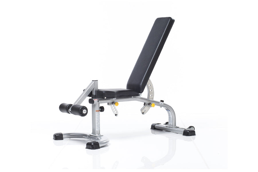 TuffStuff Evolution Deluxe Multi Purpose Bench with adjustable backrest, silver metal frame, black padding, and leg extension