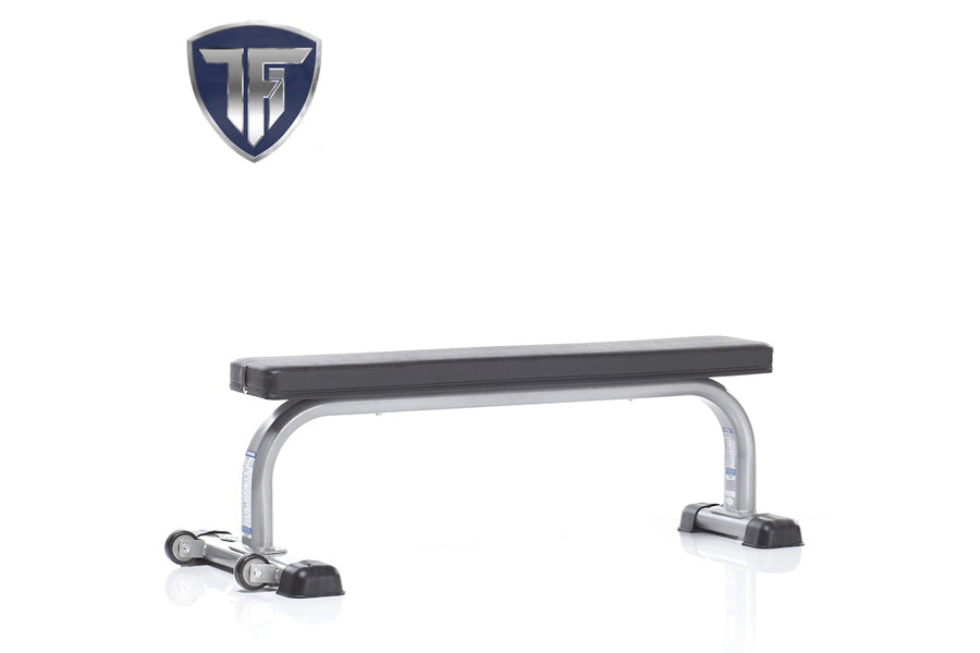 TuffStuff Evolution flat bench with black padded seat, silver metal frame, and dual stabilizer feet on white background
