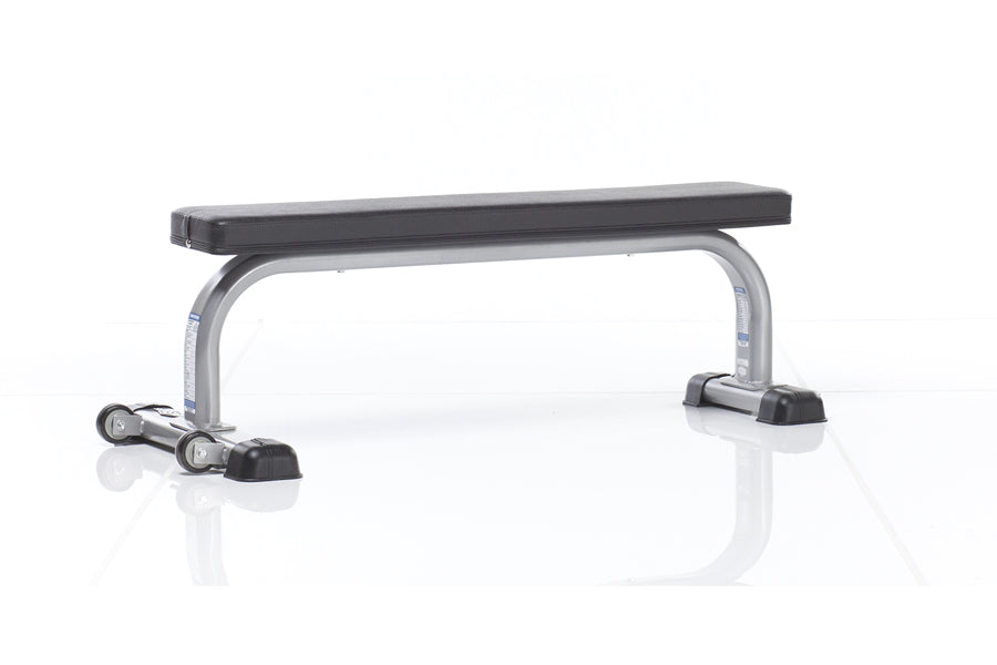 TuffStuff Evolution flat weight bench with black padded seat, silver metal frame, and black base feet on white background