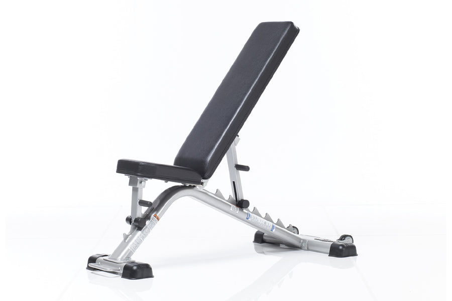 TuffStuff Evolution flat and incline weight bench with black padded seat and silver metal frame on white background