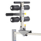 TuffStuff Evolution Glute/Ham Bench with gray steel frame, black padded roller attachments, and T-bar handlebar on white back