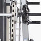 TuffStuff Evolution Smith Machine with half cage ensemble, white uprights with black horizontal bars and weight plates mounte
