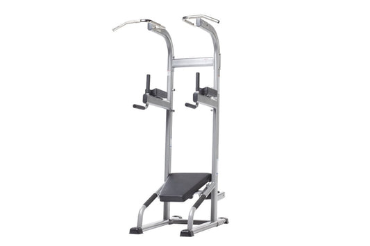 Vertical knee raise and dip station with silver metal frame, black foot platform and padded arm supports on white background
