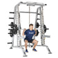 TuffStuff Evolution silver Smith machine with half cage combo, man in navy shirt performing squat with barbell, loaded weight
