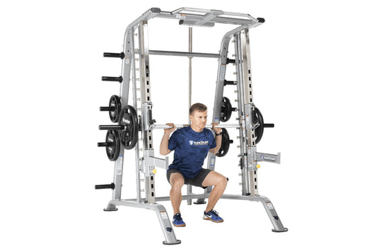 TuffStuff Evolution silver Smith machine with half cage combo, man in navy shirt performing squat with barbell, loaded weight
