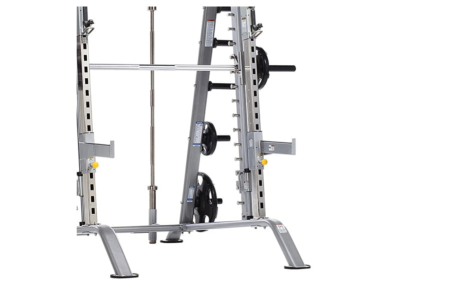 Smith machine and half cage combo with silver metal frame, weight plate storage pegs, barbell bar, and adjustable safety catc