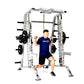 Silver and black Smith machine with half cage combo, man in blue shirt performing barbell squat exercise on white background