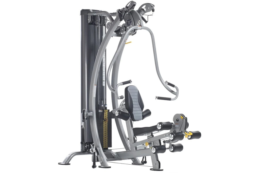 TuffStuff Hybrid Home Gym SXT-550 with gray frame, dual cable towers, leg press platform, and adjustable handles on white bac