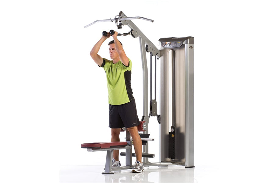Man in neon yellow shirt using stainless steel and black lat pull-down machine with adjustable seat on white background