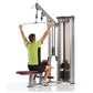 Man in lime green shirt using silver and black cable row machine against white background