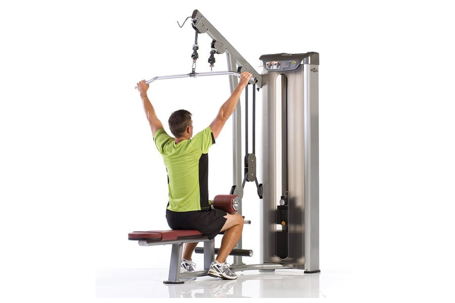 Man in lime green shirt using silver and black cable row machine against white background