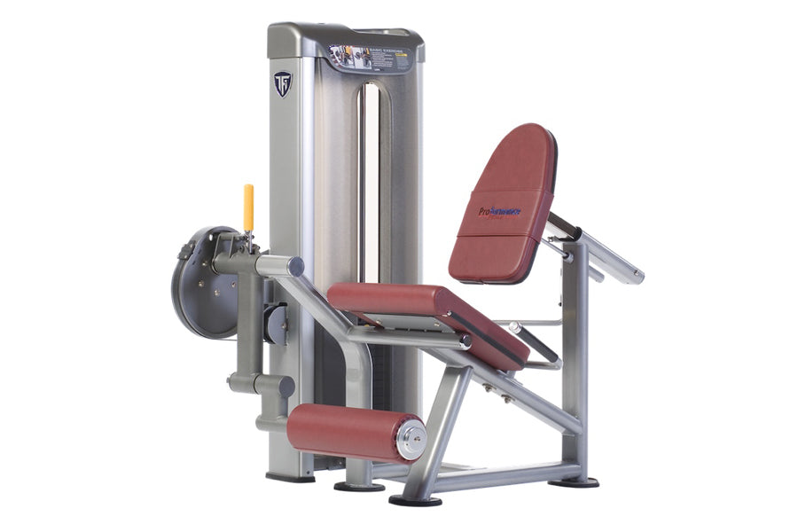 TuffStuff leg extension machine with silver frame, burgundy padded seat and backrest, weight stack on left side, against whit