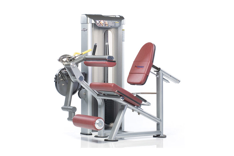 TuffStuff Abdominal Crunch Proformance Plus leg extension machine with silver frame, burgundy padded seat and backrest on whi