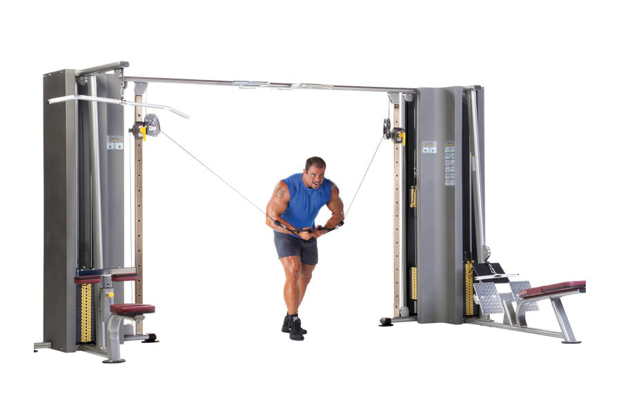 Man in blue shirt using dual cable machine for chest exercise on commercial gym equipment with gray frame