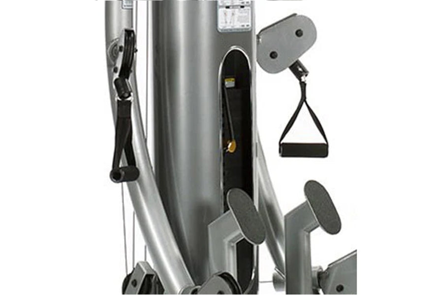 TuffStuff Six-Pak Functional Trainer with silver steel frame, black cable handles, and gray foot platforms on white backgroun