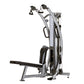 Silver and black functional trainer with dual cable stations, handlegrips, and foot pedal on white background