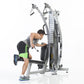 Man using silver and black dual-cable functional trainer with leg press attachment, wearing neon green tank top and black sho
