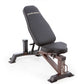 Steelbody dark gray adjustable weight bench with padded backrest and seat, brown metal frame with leg extension attachment, o