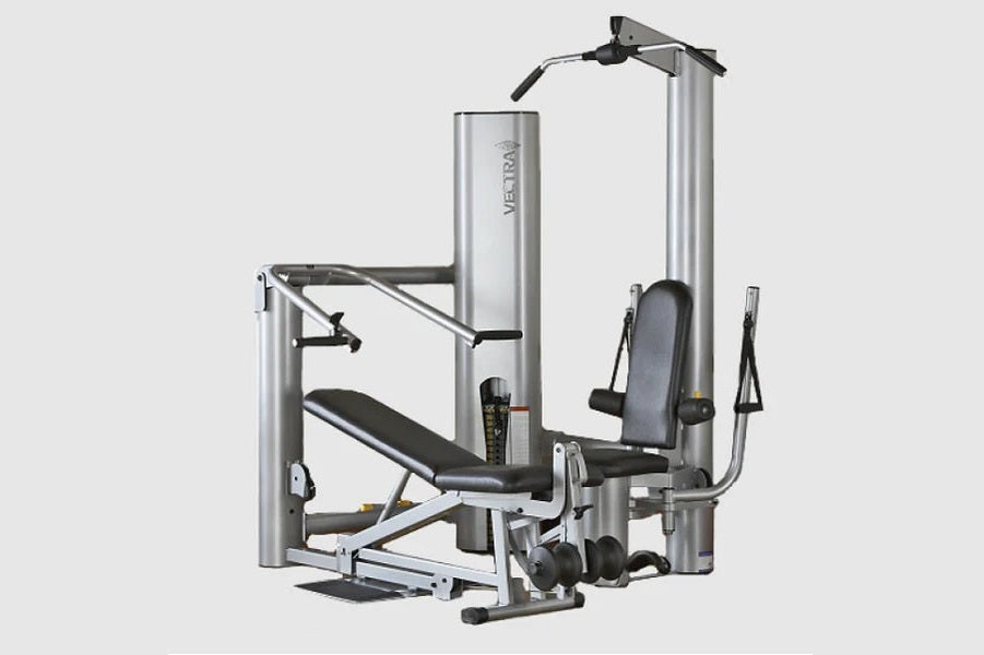 Vectra On-Line 1450 home gym with silver cylindrical towers, black padded seat, leg press platform, and cable attachment syst