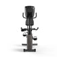 Stationary recumbent exercise bike with black and gray frame, padded seat, curved handlebars, foot pedals with straps, and di