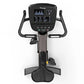 Black recumbent exercise bike with digital console display, dual handles, and wide seat on white background