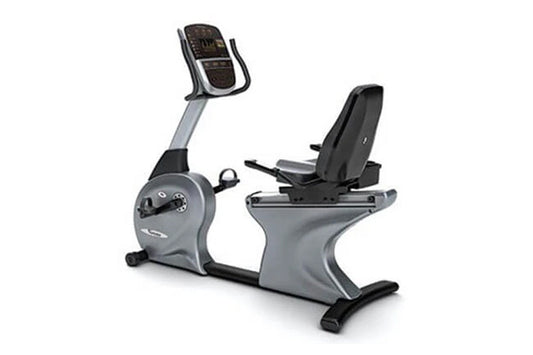 Gray and black commercial recumbent exercise bike with padded seat, handlebar display console, and footrest on white backgrou