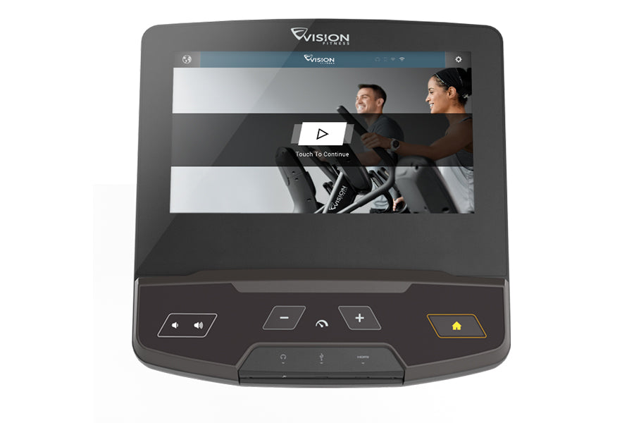 Vision S700E Ascent Trainer elliptical with touchscreen display showing workout video, control buttons, and two people exerci