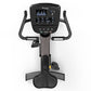 Black upright exercise bike with digital console display showing metrics, curved handlebars, and pedals on white background