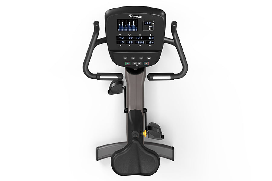 Black upright exercise bike with digital console display showing metrics, curved handlebars, and pedals on white background