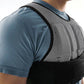 SKLZ weighted vest with mesh back panel and black straps worn by model in blue shirt