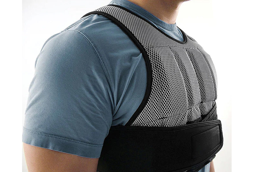 SKLZ weighted vest with mesh back panel and black straps worn by model in blue shirt