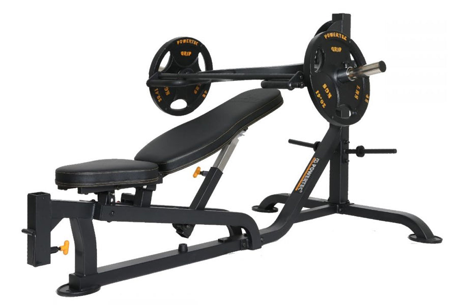 Black and gold Olympic barbell weight bench with leg extension attachment and loaded barbell plates on white background