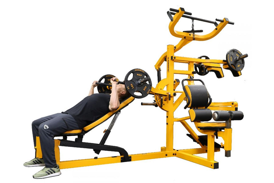 Yellow and black multi-station home gym with chest press, leg press, and lat pulldown stations, man demonstrating on white ba