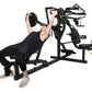 Black multisystem home gym with seated user performing chest press exercise, featuring weight plates and multiple attachment 