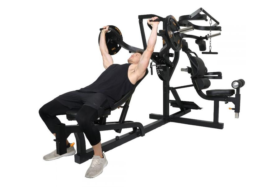 Black multi-station home gym with weight plates, featuring incline bench and leg extension attachment, model demonstrating us