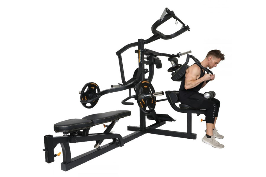 Black multi-station home gym with weight plates, bench, and cable system, model demonstrated by man in athletic wear